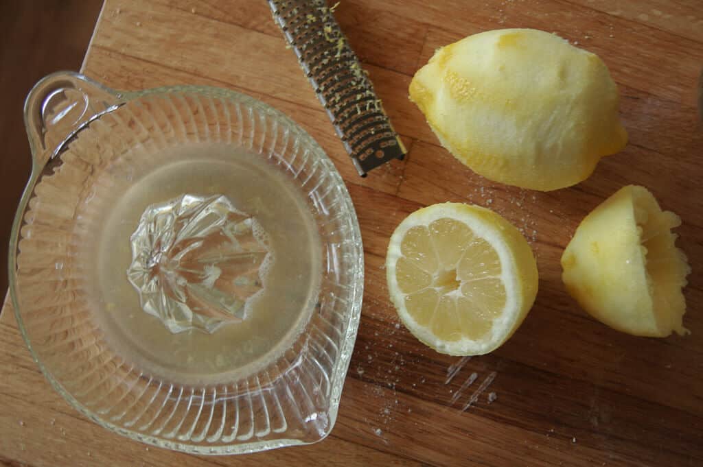 Lemons on a counter with lemon zester and juicer