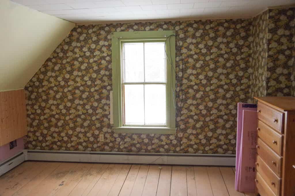 Empty room with brown floral wallpaper and window