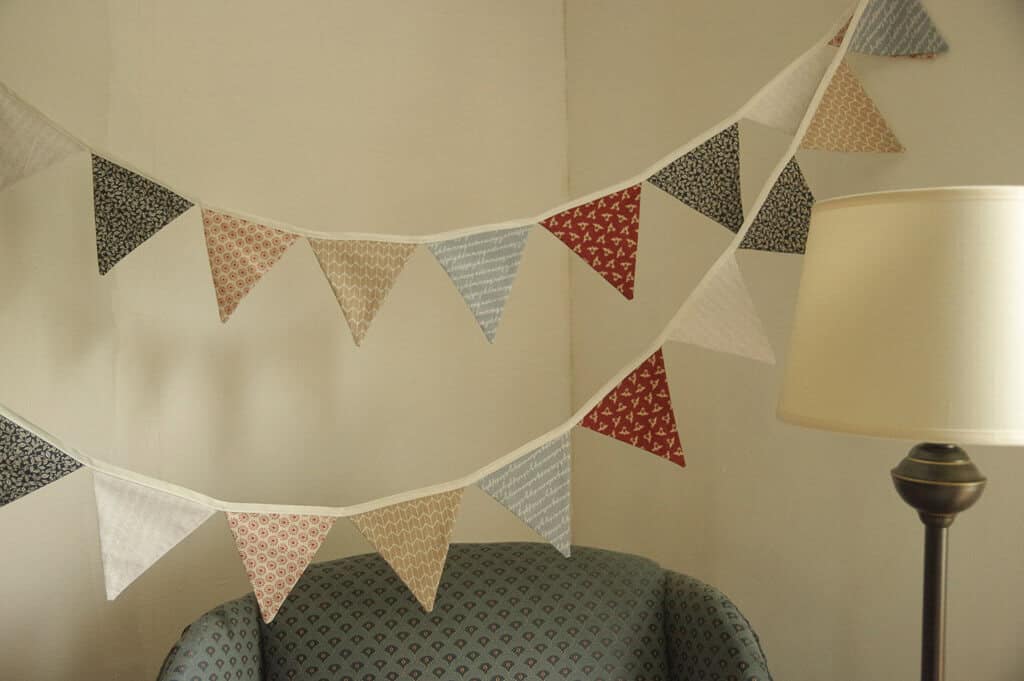 Fabric banner hanging above blue chair
