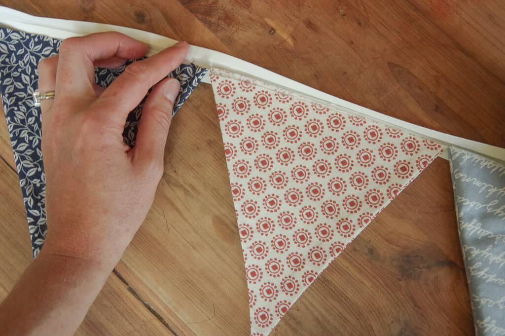 Woman's hand on top of fabric banner
