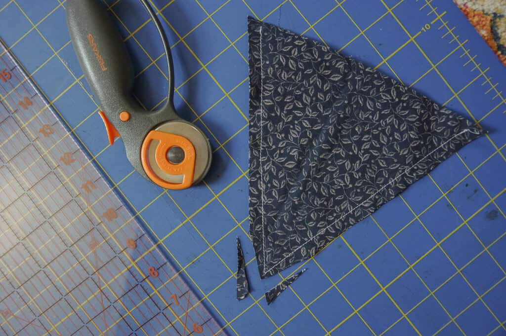 Rotary cutter and fabric flag on plastic mat
