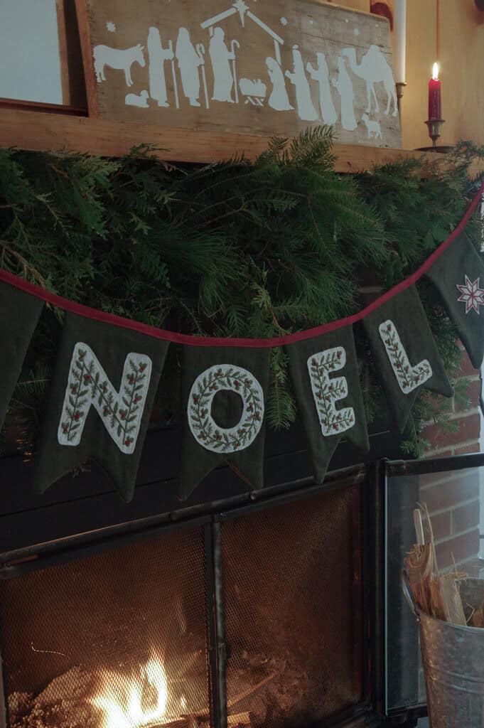 Noel banner above fireplace