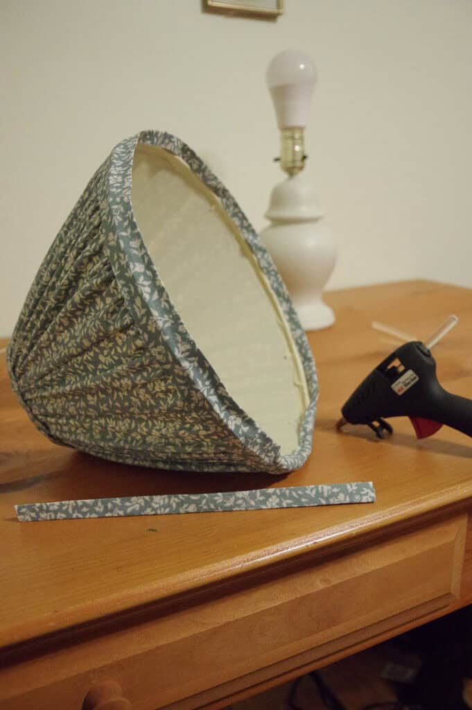 Lampshade lying on table with lamp in background