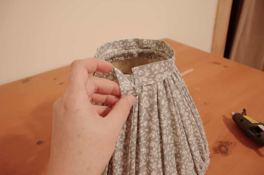 Hand holding edge of fabric