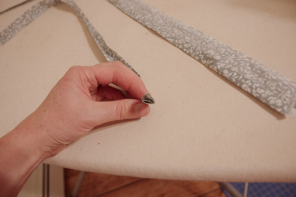 Hand holding folded strip of fabric