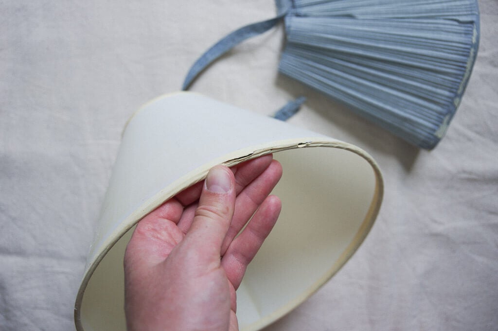 hand holding lampshade