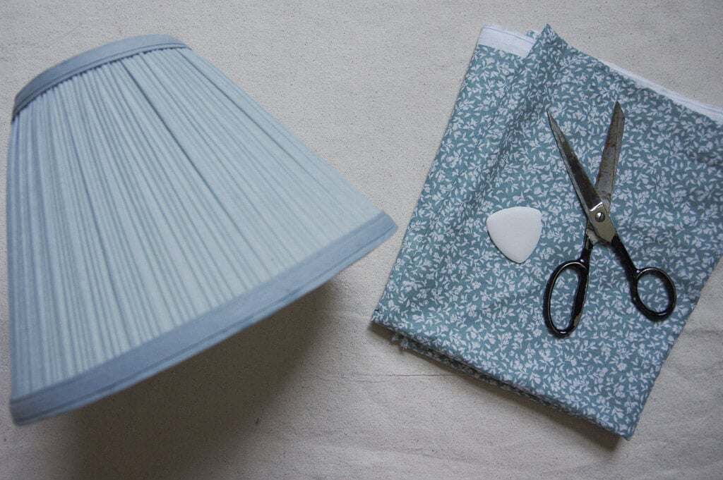 Blue lampshade, scissors and fabric