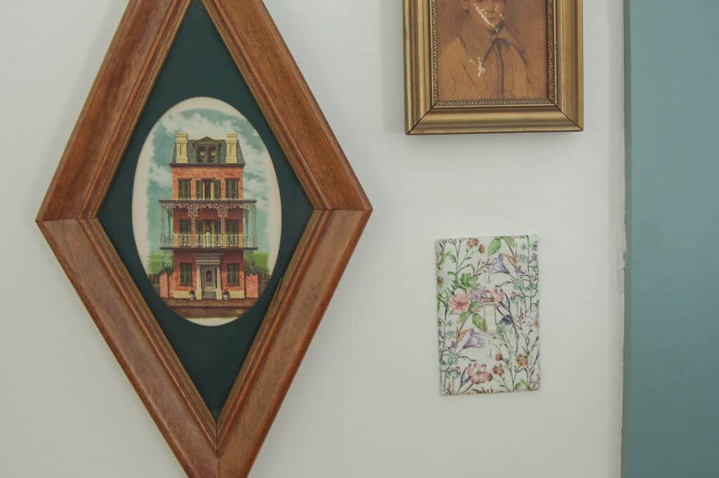 Pictures hanging on wall next to light switch 