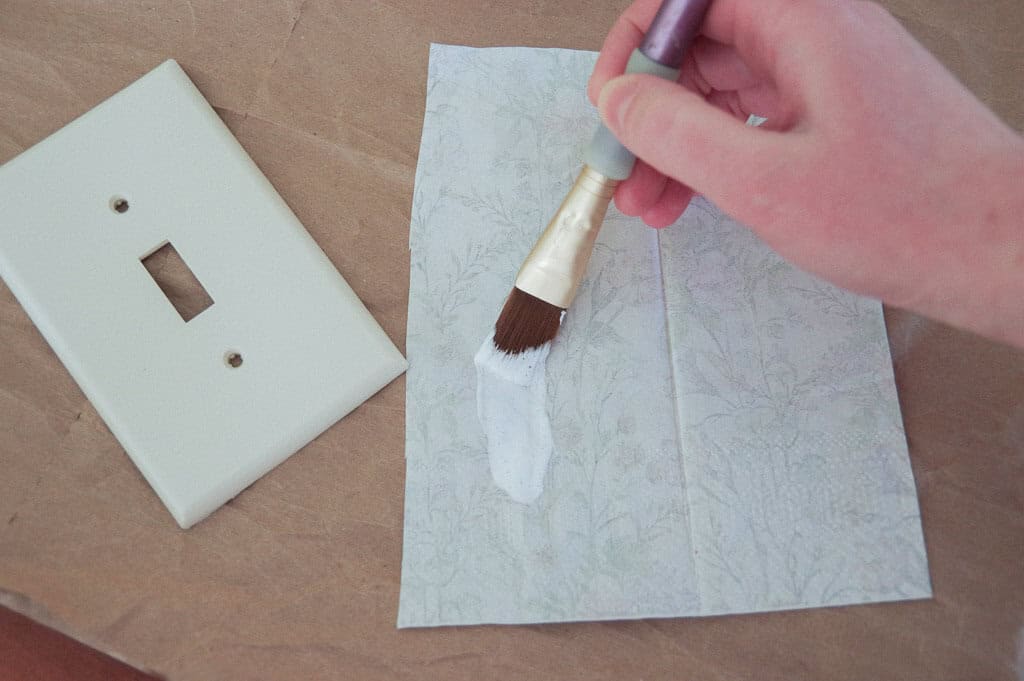 Hand painting on paper next to light switch plate