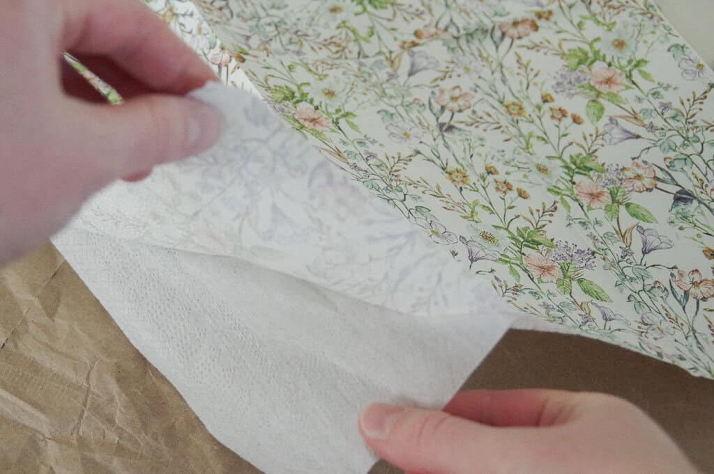 Hands pulling paper napkin apart