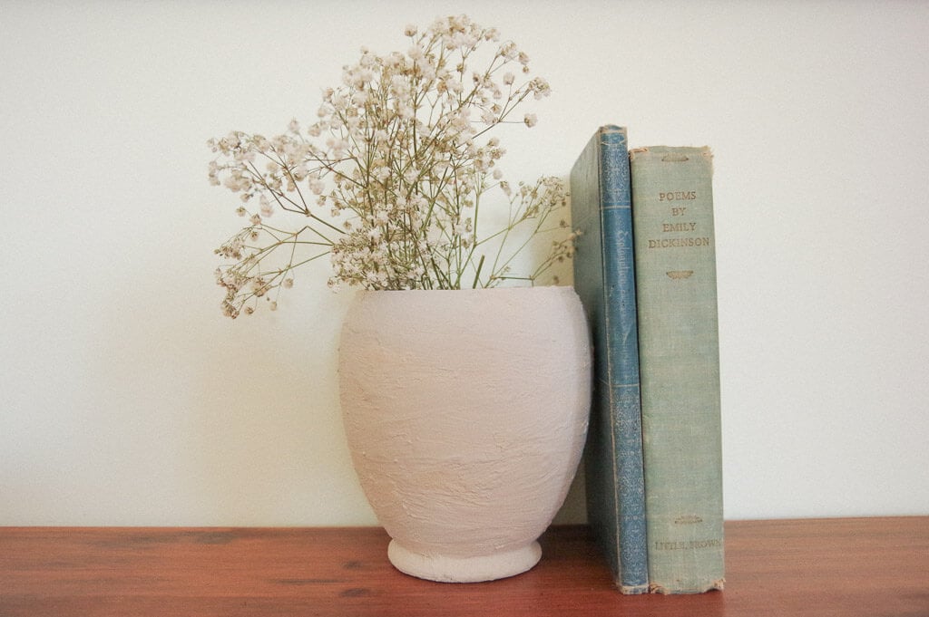 Two books and vase on desk