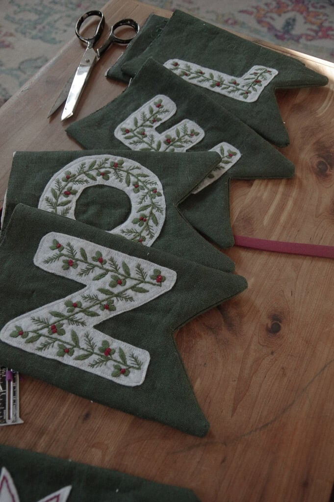 Embroidered letter banner on wooden table